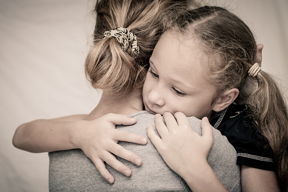 worried_mom_and_daughter_hugging